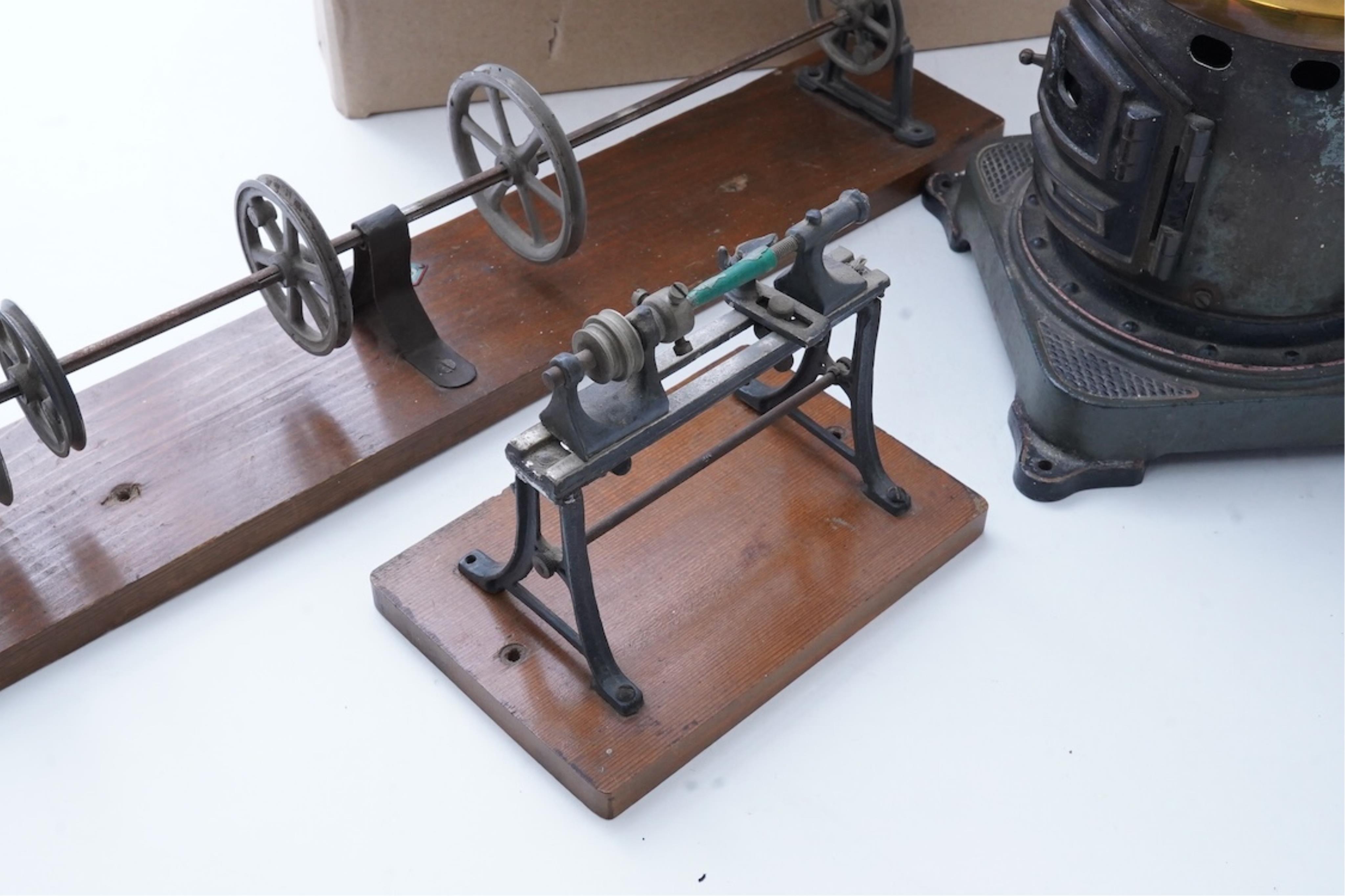 An early 20th century Bing live steam single cylinder vertical stationary engine, of brass, tinplate and cast iron construction, 38cm high, 10.5cm diameter flywheel, complete with the burner, together with a steam plant